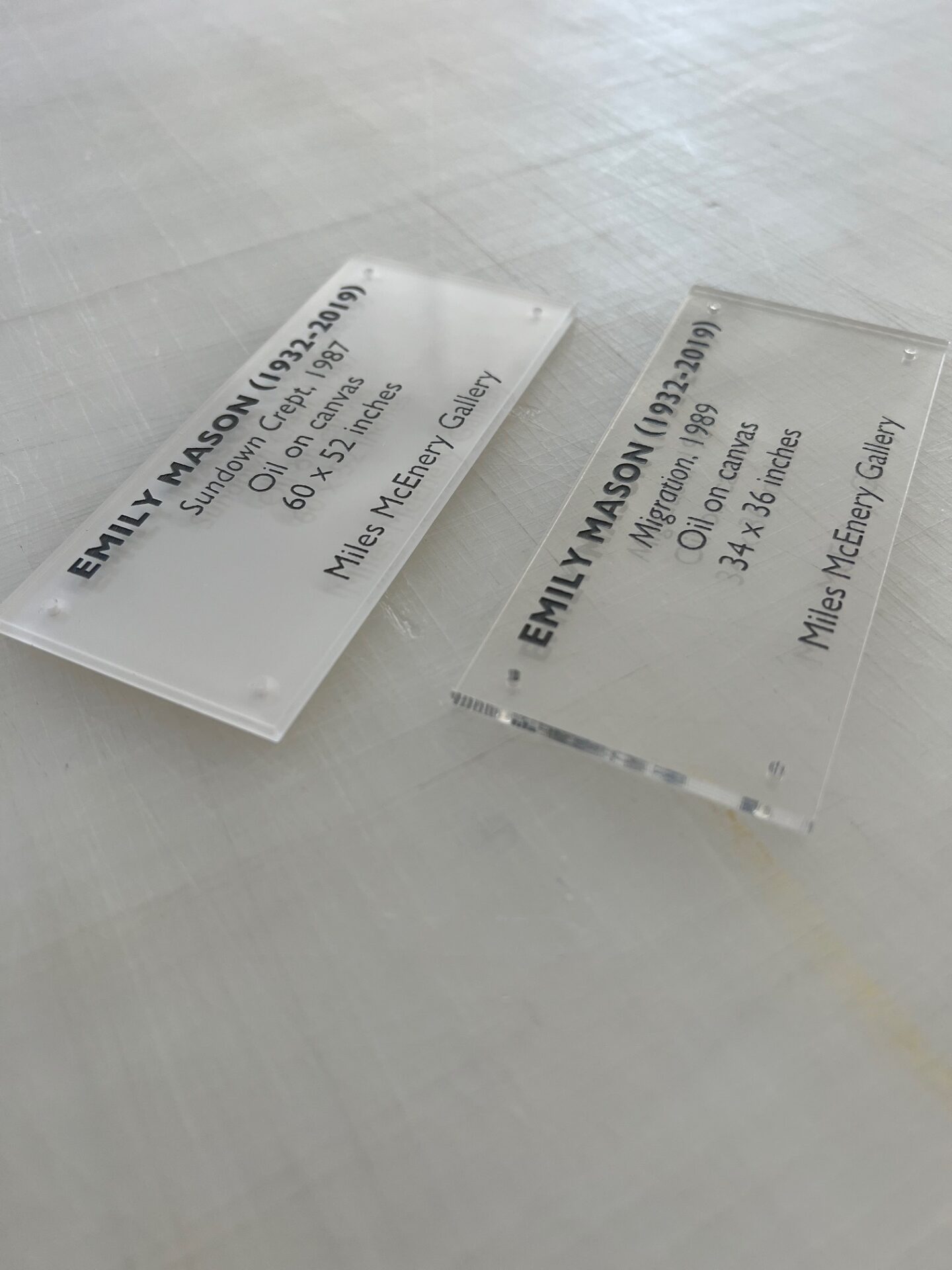 A couple of clear business cards sitting on top of a table.