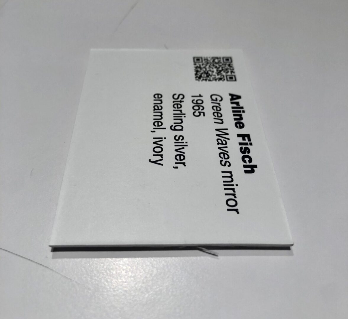 A business card with the name of the company and qr code.