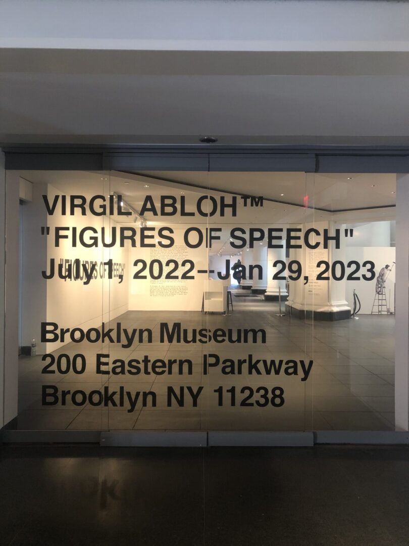 A glass window with the words virgil abloh figures of speech on it.